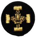 Badge de promesse, qui se porte sur la poitrine à gauche sous le badge de Louveteau.